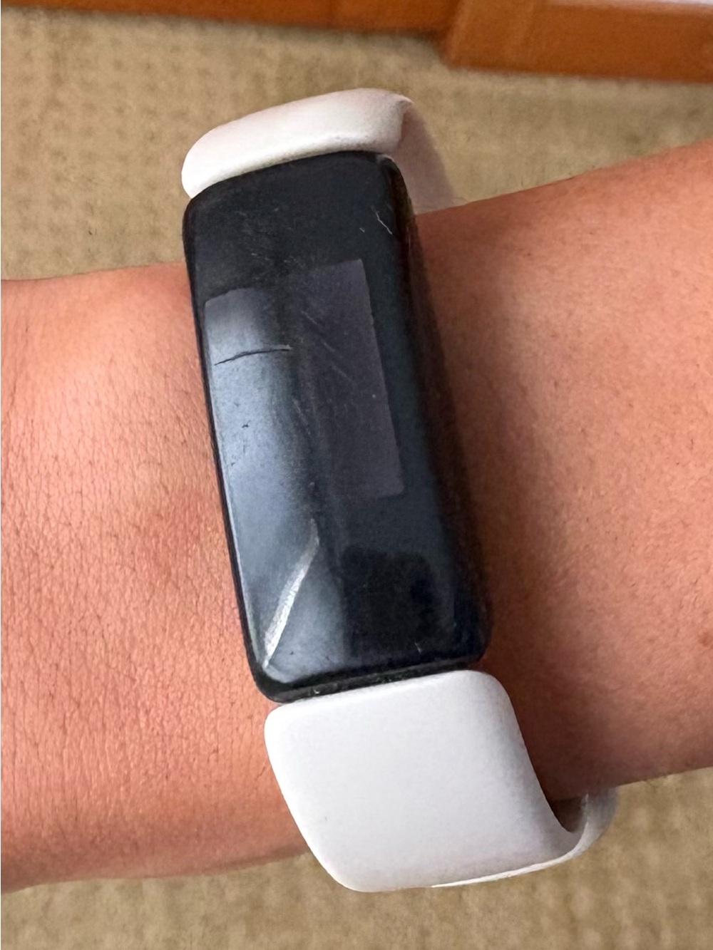 Fitbit Inspire 2 women’s Fitness Tracker with Black Display. Cream color band.
